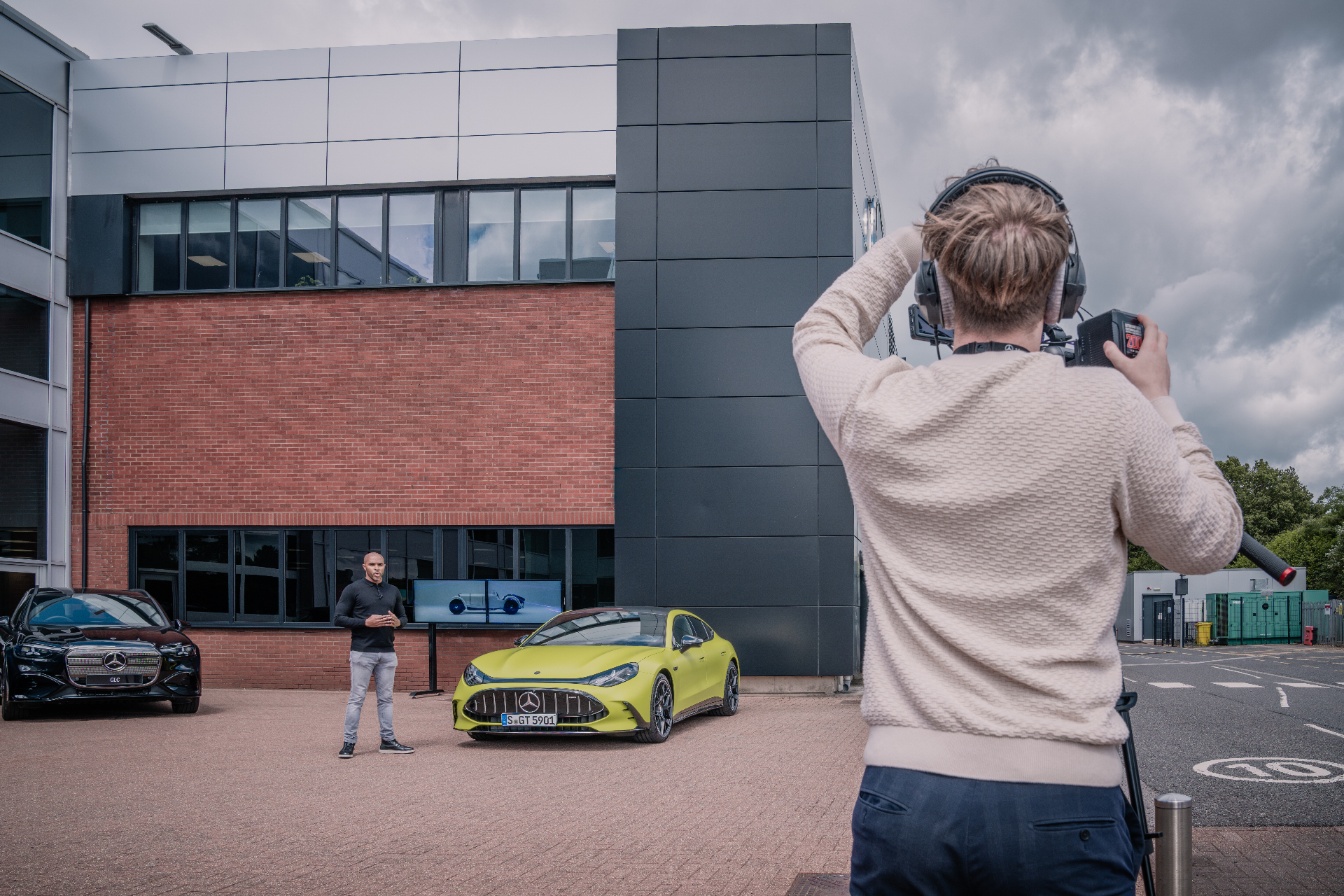 Shaun Benn presenting alongside a Mercedes-AMG GT during a filmed product feature